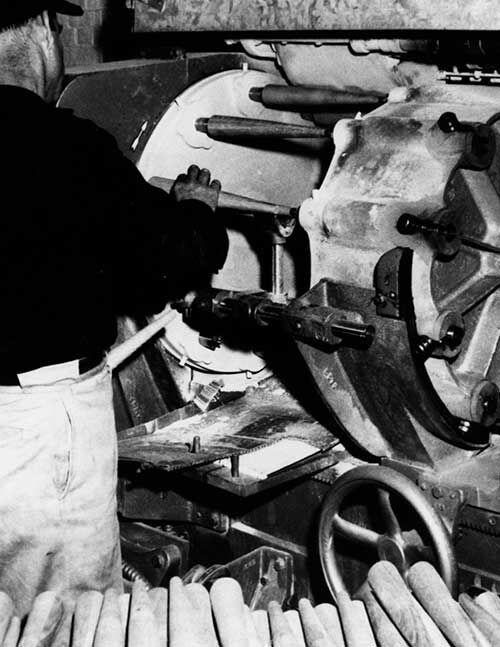 Craftsman using machine finishing chair legs Craftsman using machine finishing chair legs
