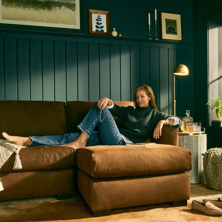 Woman sitting comfortably on Weldon leather sofa Woman sitting comfortably on Weldon leather sofa