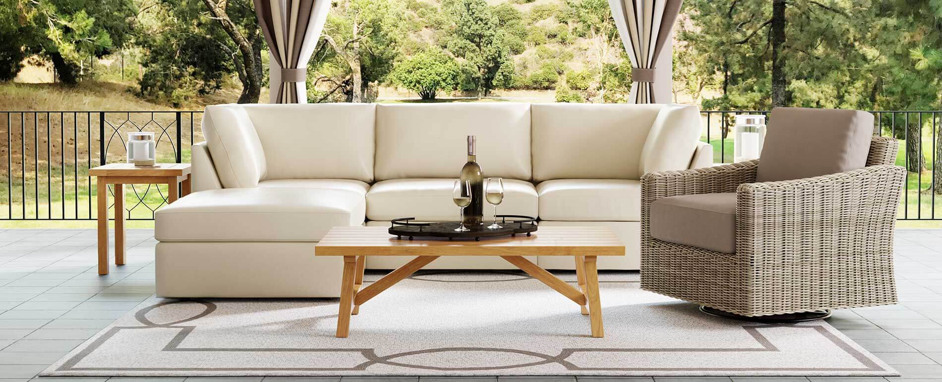 patio with chair, couch and table with wine patio with chair, couch and table with wine